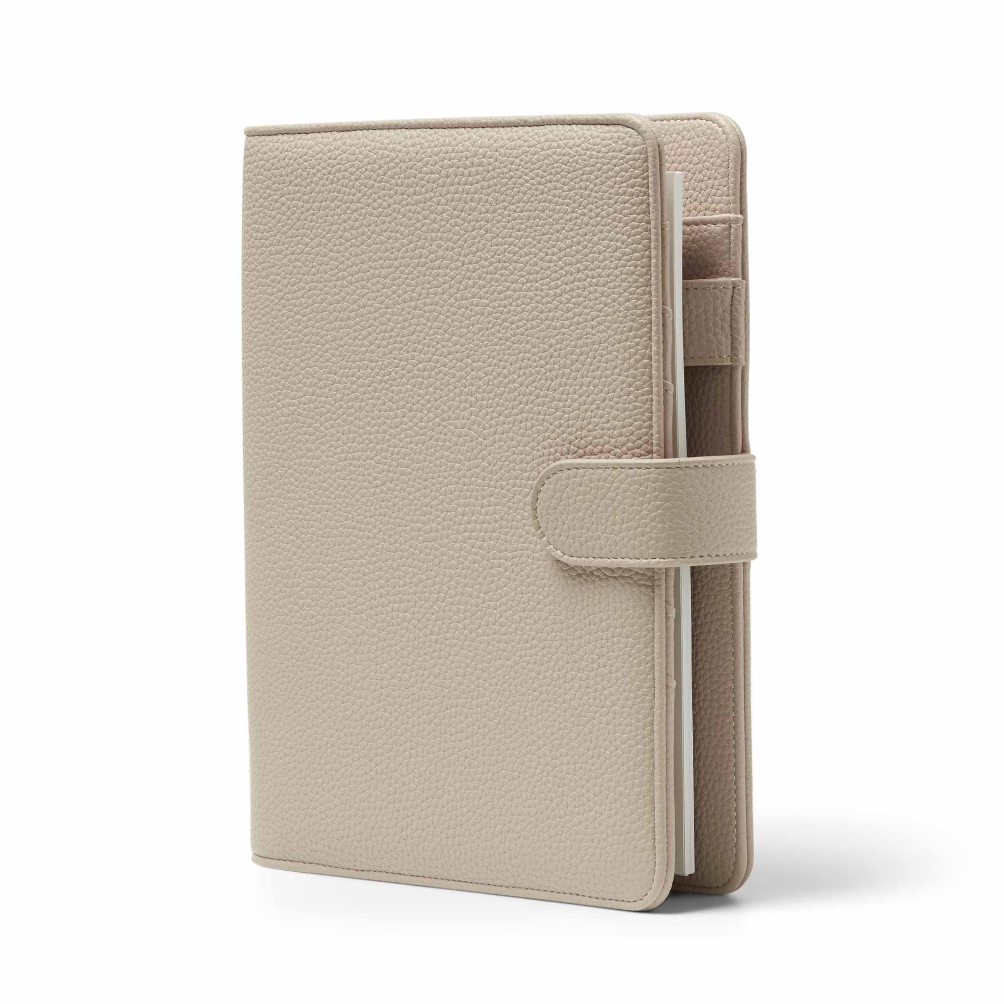 The Head Plan Agenda A5 nude vegan leather ring binder angled to show free insert pack, clasp, and pen holder #color_nude